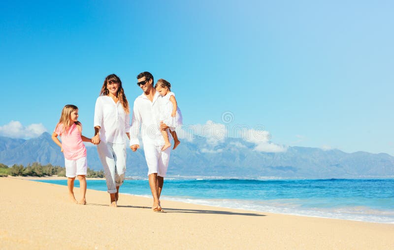 Family walking together along a sunny beach